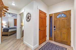 The main entrance with Texasstyle décor welcomes you into this property. A glimpse of the bedroom hints at the comfort awaiting beyond the open doorway.