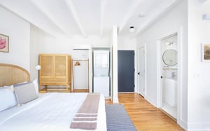 A stacking washer and dryer hide behind the cabinet.