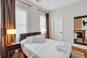 Perfect size bedroom with queen bed, flat screen TV, and large closet