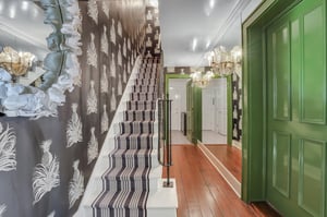 The foyer on the ground level connects to a second laundry room and the fourth bedroom.