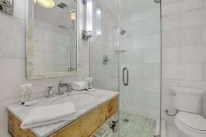 The ensuite bathroom features a beautiful marble tiled shower.