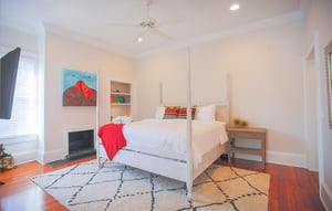 The primary suite showcases a king size four poster bed.