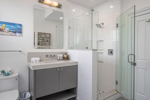The ensuite bathroom offers a large vanity, walkin shower and also connects to the hallway.