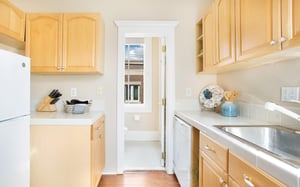 The kitchen leads into the bathroom.