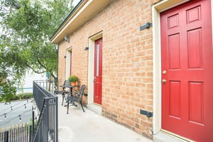 The carriage house has three bright red doors.