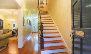 The entry to the townhome leads to a grand staircase on the right, and formal living and dining room on the left.
