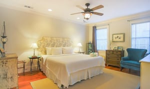 On the second floor, there are two beautiful bedrooms. This room features a king bed and ensuite bath as well as a view of the courtyard.