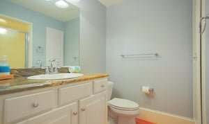 This bath has beautiful granite countertops and a standing shower.
