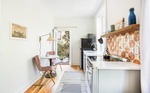 The full kitchen is adjacent to an eating nook for two.