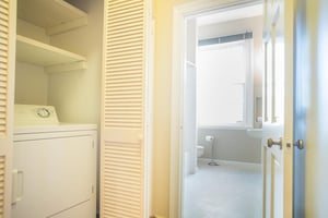 A washer and dryer are in the hall on the second floor.