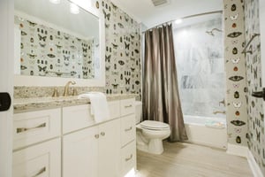 The bathroom features automatic floor lights, a marble tiled shower and tub combo, plus an oversized vanity.