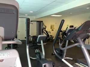 Workout room next to indooroutdoor pool. Locker room, a floor below.