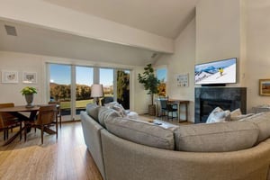 Comfortable living room with 50” smart TV, gas fireplace, and work desk