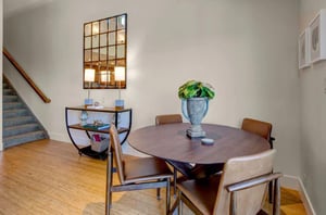 Dining area with a table and chairs for four guests.