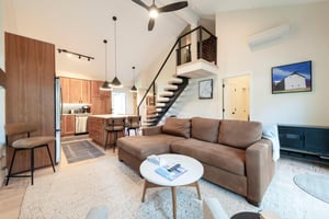 Open kitchen with new appliances  island seating.
