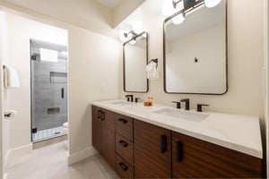 Bright master bathroom with dual vanities.