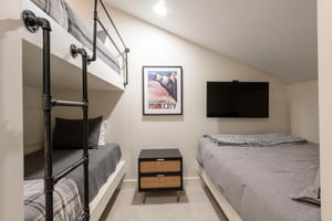 Guest bedroom with adult sized bunks plus queen bed.