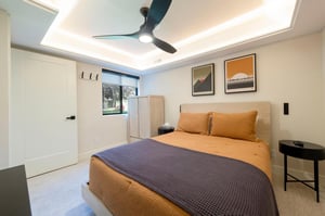 Spacious and comfortable guest bedroom with television.