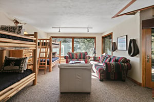 Your cozy mountain retreat features handcrafted log bunk beds with living space,  walk out to the hot tub on the deck.