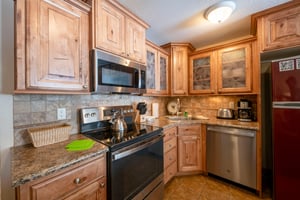 The fully equipped kitchen at Park Avenue 211 features stainless steel appliances, granite countertops, and plenty of space to prepare your favorite meals.