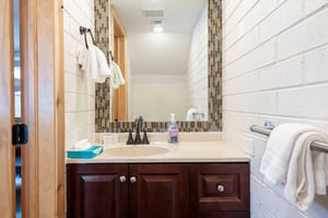 A stylishly updated half bath on the main level of Park Avenue 235 adds everyday convenience for guests and entertaining.
