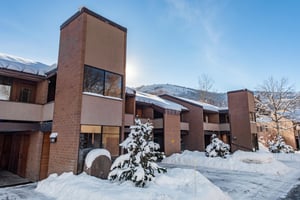 The inviting front entrance of Park Avenue 211 welcomes you home after a day on the slopes — with assigned carport parking for one vehicle just steps away.