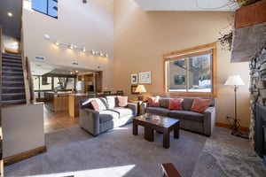 Room for everyone. This sunfilled living area flows seamlessly into the kitchen, making it easy to settle in and stay a while at this Park City condo rental.