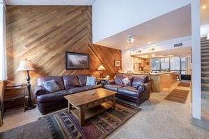 Warm wood accents, plush leather seating, and an open flow into the kitchen — Park Avenue 231 is designed for effortless mountain living.