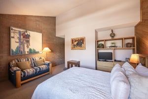 Warm tones, curated artwork, and a relaxed layout make this inviting bedroom at Park Avenue 243 a standout feature of one of Park Citys most distinctive lodging experiences.