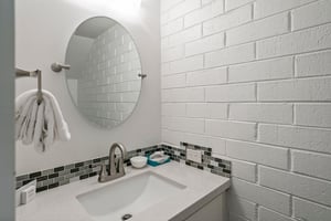 The stylish half bathroom on the main level of Park Avenue 296 features modern finishes and chic subway tile walls, adding a designer touch to this already impressive Park City vacation rental.
