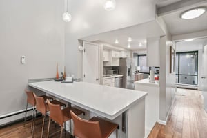 The sleek and modern kitchen at Park Avenue 296 features a generous quartz breakfast bar, perfect for casual dining and gathering. Clean lines and contemporary finishes make this one of the most styli