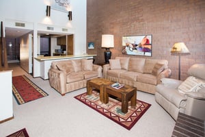With room for everyone to relax, the open living area at Park Avenue 314 is the heart of this inviting Park City condo rental. Soaring ceilings, warm brick accents, and a cozy layout make it the perfe