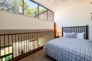 Wake up to natural light and lush treetop views in the charming queen bedroom at Park Avenue 333. The open, loftinspired layout and classic plaid bedding give this Park City condo rental a cozy yet a
