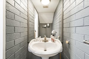 Every detail counts at Park Avenue 333, right down to the charming main floor half bathroom. Exposed brick walls and a classic pedestal sink give this space a unique character that perfectly complemen