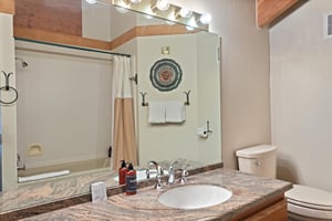 Fresh, clean, and thoughtfully stocked, this wellappointed bathroom at 1296 Pinnacle features warm granite countertops and all the amenities you need for a comfortable Park City vacation rental exper