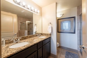 The primary ensuite at Bear Hollow 4402 features dual sinks, granite countertops, and a walkin shower — everything you need to refresh and recharge during your Park City vacation rental stay.
