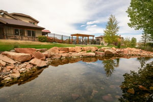 The beautifully landscaped grounds at Bear Hollow feature a serene pond and outdoor gathering spaces, adding to the resortlike atmosphere of this Park City vacation rental community.