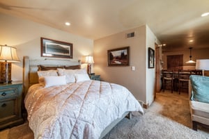 Rest and recharge in the comfortable queen bedroom at Jupiter Inn 17, featuring warm decor and a peaceful atmosphere. A welcoming retreat within this Park City vacation rental.