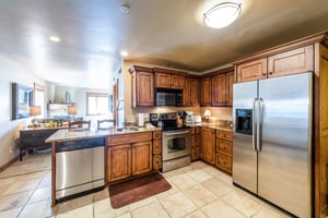 Cook with ease in the wellstocked kitchen at Jupiter Inn 17, complete with stainless steel appliances and plenty of storage. A great amenity that makes this Park City condo rental feel just like home