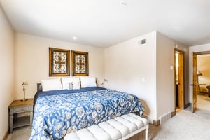 The beautifully appointed bedroom at Jupiter Inn 18 features a comfortable kingsize bed and elegant decor, offering a peaceful retreat during your Park City vacation rental stay.