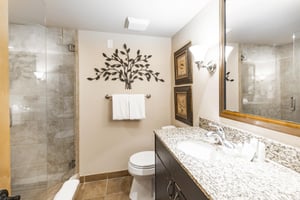 Fresh and stylish, the bathroom at Jupiter Inn 18 combines granite countertops and a walkin shower with tasteful decor. A polished and inviting space within this Park City condo rental.
