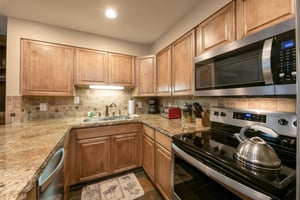 Resort Plaza 5002 has everything you need to feel at home — this wellappointed Park City condo rental kitchen features stainless steel appliances, granite countertops, and beautiful tile backsplash f