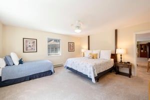 Another spacious and welcoming guest bedroom at Resort Plaza 5004 — this Park City vacation rental offers comfortable multibed sleeping arrangements, warm natural light, and classic mountain lodge dé