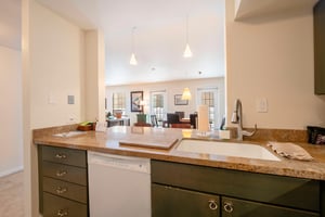 Stay in the heart of it all from the kitchen at Resort Plaza 5007 — this airy and open Park City condo rental layout with warm countertops and stylish dark cabinetry makes every gathering feel effortl
