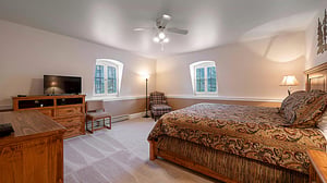Resort Plaza 5013 offers a spacious king bedroom with natural light and cozy seating — a standout feature of this premier Park City condo rental and Park City lodging destination.