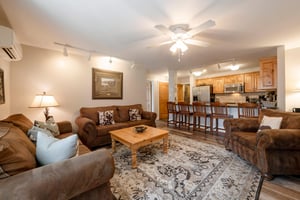 Settle into the warm and inviting living area at Resort Plaza 5022 — a spacious Park City vacation rental with comfortable seating and an open flow into the kitchen.