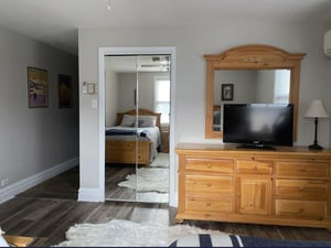 Resort Plaza 5022 features a wellfurnished bedroom with a classic pine dresser and TV — a comfortable and thoughtfully appointed Park City vacation rental for your mountain stay.