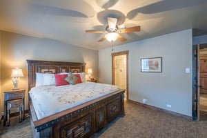 Sleep soundly in the generously sized bedroom at Resort Plaza 5009 — a standout Park City condo rental offering a gorgeous carved wood bed, soft neutral tones, and a peaceful atmosphere perfect for yo