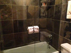 Dark dramatic tile surrounds the tub and shower at Resort Plaza 5022 — a sophisticated finishing touch in this comfortable Park City condo rental and Park City lodging option.