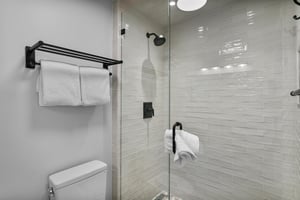 Rinse off and refresh in this beautifully tiled walkin shower, featuring sleek matte black fixtures and a clean, modern design. Spalike touches like these make this Park City vacation rental truly s